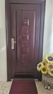 a wooden door with a vase of flowers next to it at Elena & Leila in Santa Maria a Monte