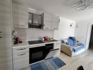 a kitchen with a sink and a stove at La Casina Procchio loc I Marmi in Procchio