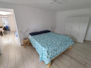 a bedroom with a bed with a blue blanket on it at La Casina Procchio loc I Marmi in Procchio