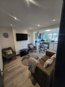 a living room with a couch and a table at White Shelf Dartford House in Kent