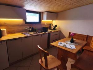 a kitchen with a table and a sink and a table and chairs at Chata Vrcov in Vrcov