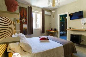 ein Krankenzimmer mit einem Bett, auf dem ein rotes Kissen liegt in der Unterkunft Agrigento Bed in Agrigento