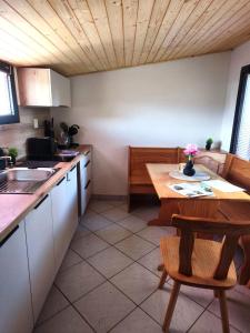 a kitchen with a wooden table and a tableasteryasteryasteryasteryasteryasteryastery at Chata Vrcov in Vrcov +17 photos