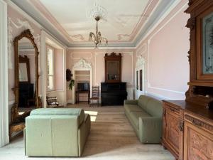a living room with a couch and a mirror at Zucca s home in Baveno