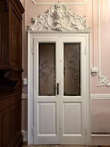 a white door with glass in a room at Zucca s home in Baveno