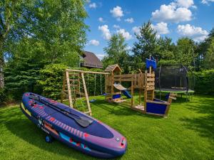 a small inflatable boat sitting on a playground at Lake House Szteklin in Szteklin