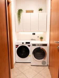 a laundry room with a washer and dryer at Stile e comfort! in Trecate