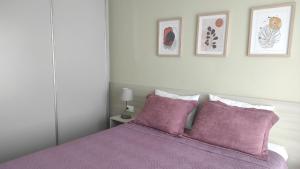 a bedroom with a purple bed with two purple pillows at Villa Aias- Private Olive Grove Retreat in Plakias