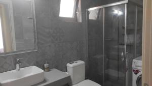 a bathroom with a shower and a toilet and a sink at Villa Aias- Private Olive Grove Retreat in Plakias +20 photos