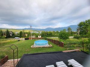 a backyard with a trampoline and a pool at Casa Claudiu in Eşelniţa