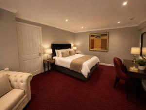 a hotel room with a bed and a couch at Primrose Manor in Risley