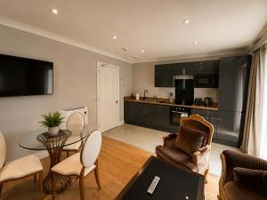a living room with a couch and a table at Primrose Manor in Risley