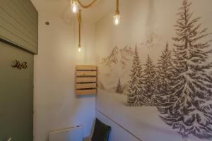 a wall with a drawing of a forest on it at La grande Sure & Spa in Voiron
