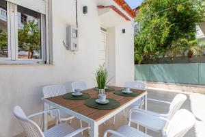 a wooden table and chairs on a patio at Casa Lili in Platanias