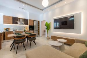 a kitchen and living room with a couch and a table at Casa Lili in Platanias