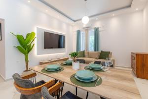 a dining room and living room with a table and chairs at Casa Lili in Platanias