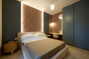 a bedroom with a large bed and a desk at Oltremare Luxury Suites in Otranto