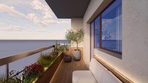 a balcony with a view of the ocean at Oltremare Luxury Suites in Otranto