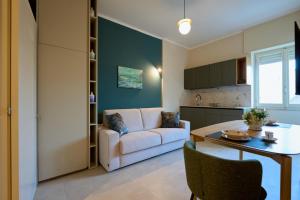 a living room with a couch and a table at Oltremare Luxury Suites in Otranto