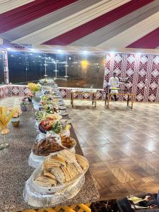 a long table with many plates of food on it at SaLem rum in Wadi Rum