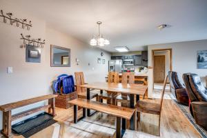 a dining room and kitchen with a table and chairs at Silverthorne Condo: New Pool & Hot Tub + Fireplace in Silverthorne