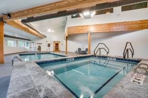 a large indoor swimming pool in a building at Silverthorne Condo: New Pool & Hot Tub + Fireplace in Silverthorne