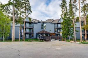 a large blue building with trees in front of it at Silverthorne Condo: New Pool & Hot Tub + Fireplace in Silverthorne