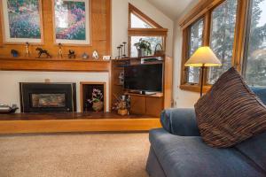 a living room with a blue couch and a fireplace at Quicksilver #1602 in Keystone