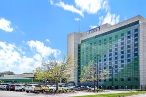 a hospital building with cars parked in a parking lot at Broadway Inn in Council Bluffs