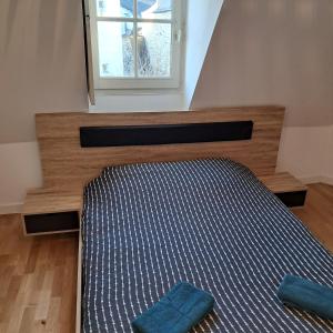 a bedroom with a bed with a mirror on the wall at le pomerol in Château-Gontier