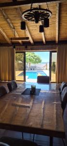 a large wooden table in a room with a pool at Villa Granda in Visočane