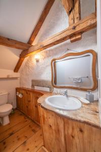a bathroom with a sink and a mirror at Hôtel Von Bergen in La Sagne +30 photos