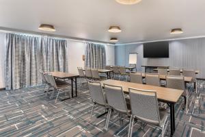 a conference room with tables and chairs and a screen at Best Western Plus Rialto in Rialto +83 photos