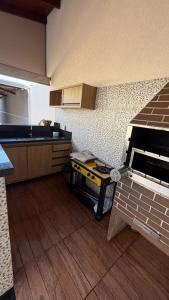 a kitchen with a counter and a table in it at Casa queen in Campo Grande