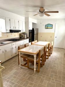 a kitchen with a table and chairs and a refrigerator at Sea Kist Motel in Wildwood