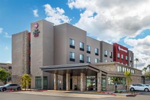 a hotel building with cars parked outside of it at Best Western Plus Rialto in Rialto