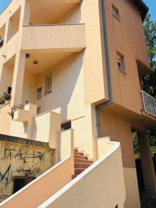 a building with graffiti on the side of it at Apartment Oak Root in Mostar