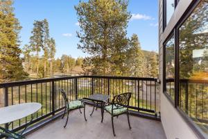a balcony with a table and two chairs and a table at Quicksilver #1631 in Keystone