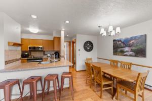 a kitchen and dining room with a wooden table and chairs at Quicksilver #1631 in Keystone