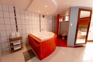 a bathroom with a tub and a sink in it at Hostal Los Cactus in Lima +12 photos