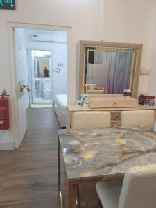 a living room with a table and a mirror at Ontrack Travel in Male City