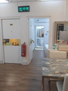 a room with a clock on the wall and a fire hydrant at Ontrack Travel in Male City