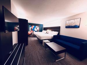 a hotel room with a bed and a couch at Holiday Inn Express Hotel & Suites Chester by IHG in Chester