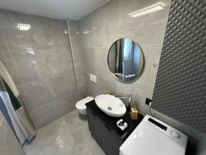 a bathroom with a sink and a mirror and a toilet at Apartment Dantéa Novéa - NEW 2026 in Izola +13 photos