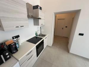 a small kitchen with a sink and a stove at Apartment Dantéa Novéa - NEW 2026 in Izola