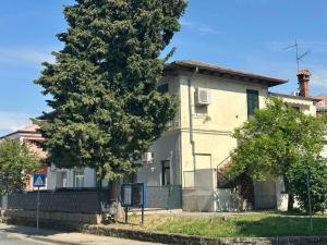 an old house with a tree in front of it at Apartment Dantéa Novéa - NEW 2026 in Izola