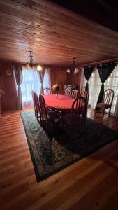 a dining room with a red table and chairs at Jazz House Pucon in Pucón