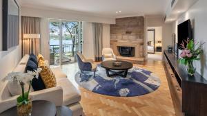 a living room with a couch and a table at InterContinental Sanctuary Cove Resort by IHG in Gold Coast