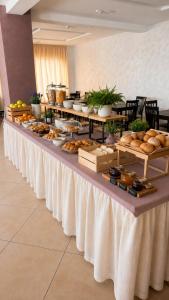 a buffet line with bread and pastries on it at Hotel Villa Tina Easy Stay B&B in Cesenatico +16 photos