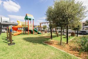 a playground with a slide in a park at Zoe Lodge in Midrand